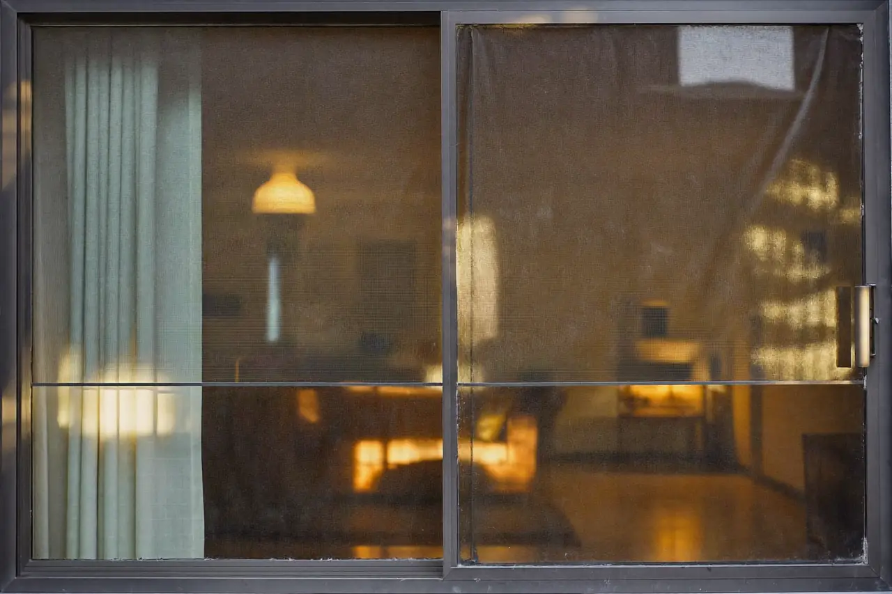 Low emissivity coated glass reflecting warm interior light