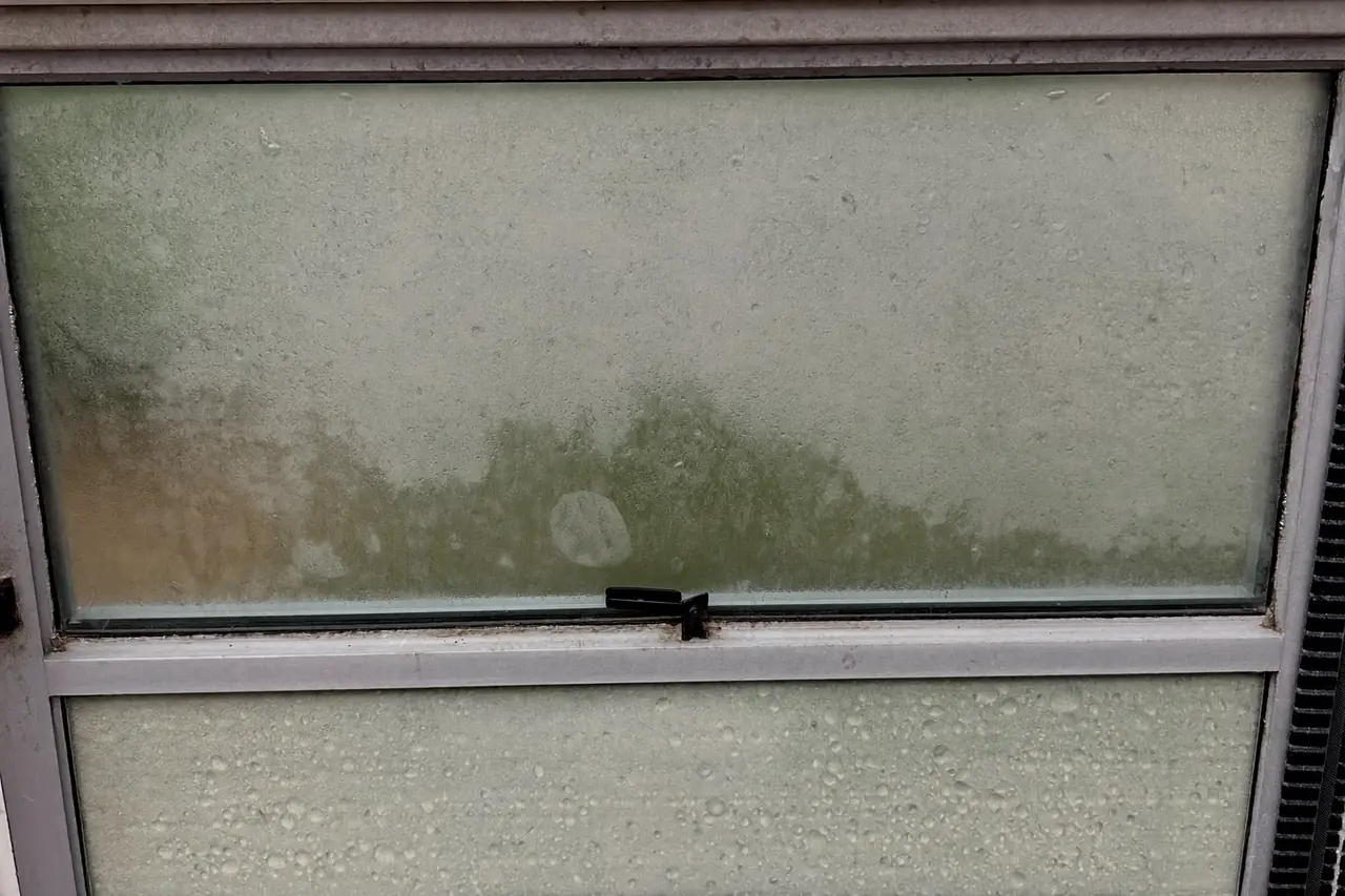 Misted double glazing unit with condensation trapped between the panes